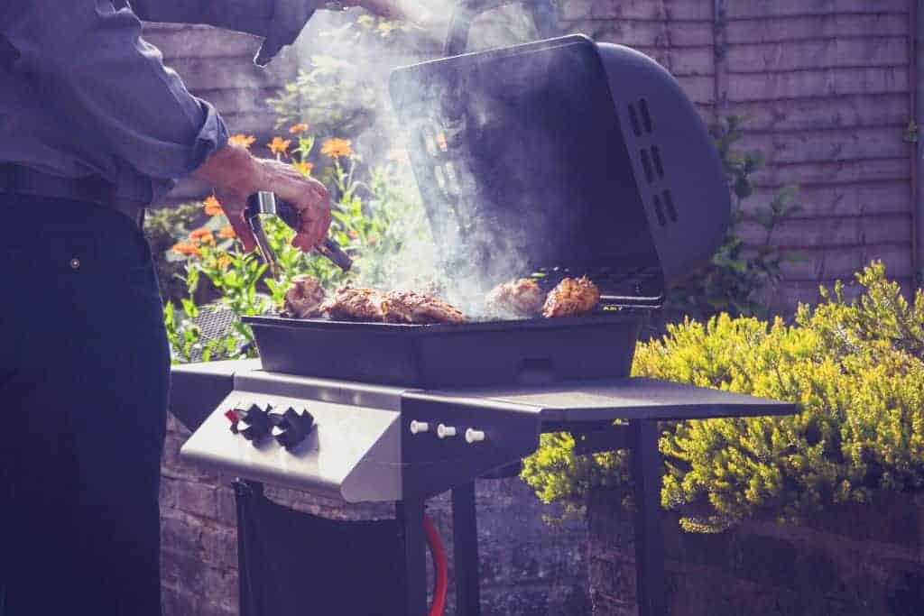 How To Smoke Meat On A Gas Grill 2 Man Barbecuing On Gas Grill