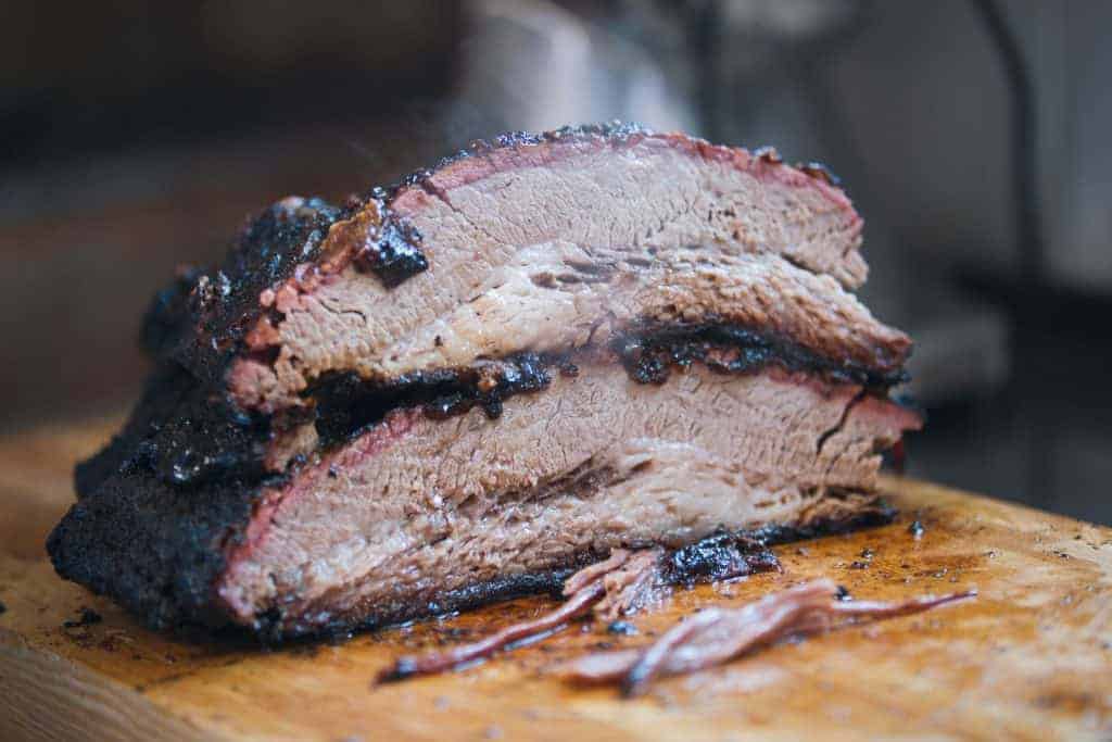 6 Tips For Taking Smoked Brisket From Average To Amazing 2 Two Large Pieces Of Smoked Brisket Meat On A Wooden Board