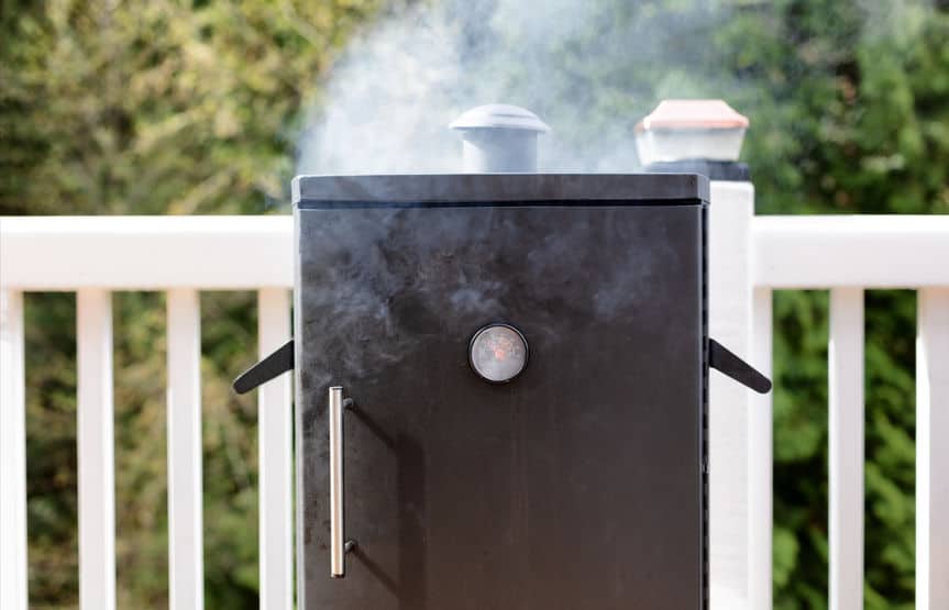 Shocking Truth of Using an Electric Smoker in the Rain 1 Close Up Of A Cooking Smoker With Woods In Background